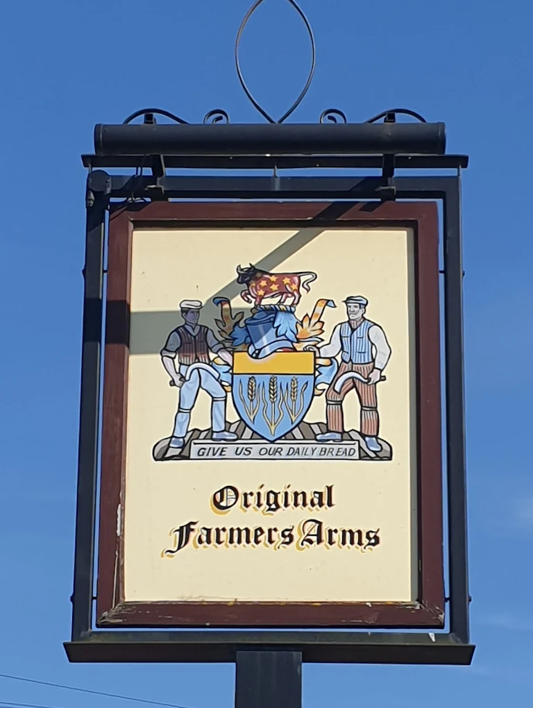 Traditional hanging pub sign with heraldic crest